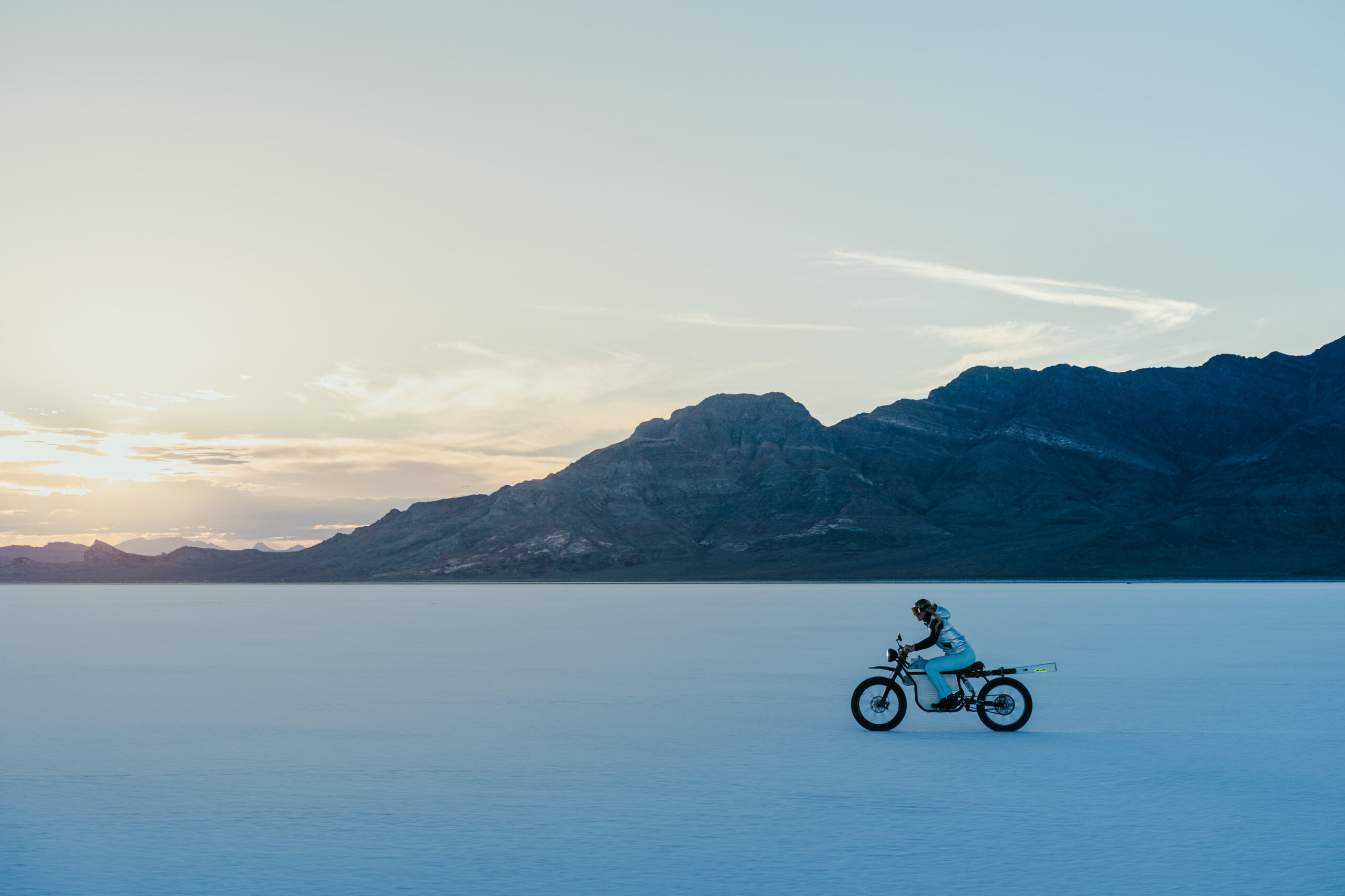 Lindsey Vonn riding a Terra Bike across the Bonneville Salt Flats at sunset.